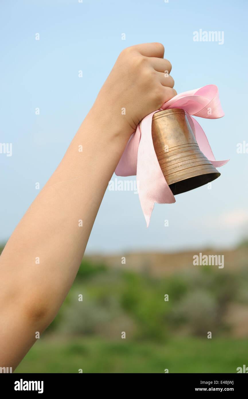 Die Hand mit einer Glocke Stockfoto