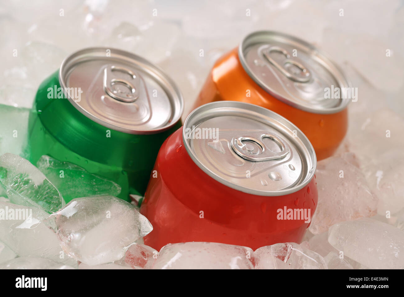 Kalte Cola und Limonade in Dosen auf Eiswürfel Stockfoto