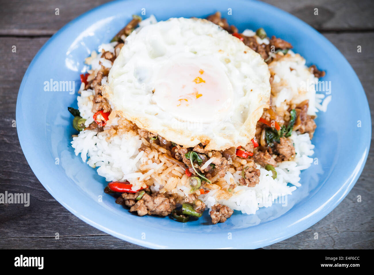 Thai scharfes Essen, Reis garniert mit gebratenes Schweinefleisch und Basilikum mit Spiegelei Stockfoto