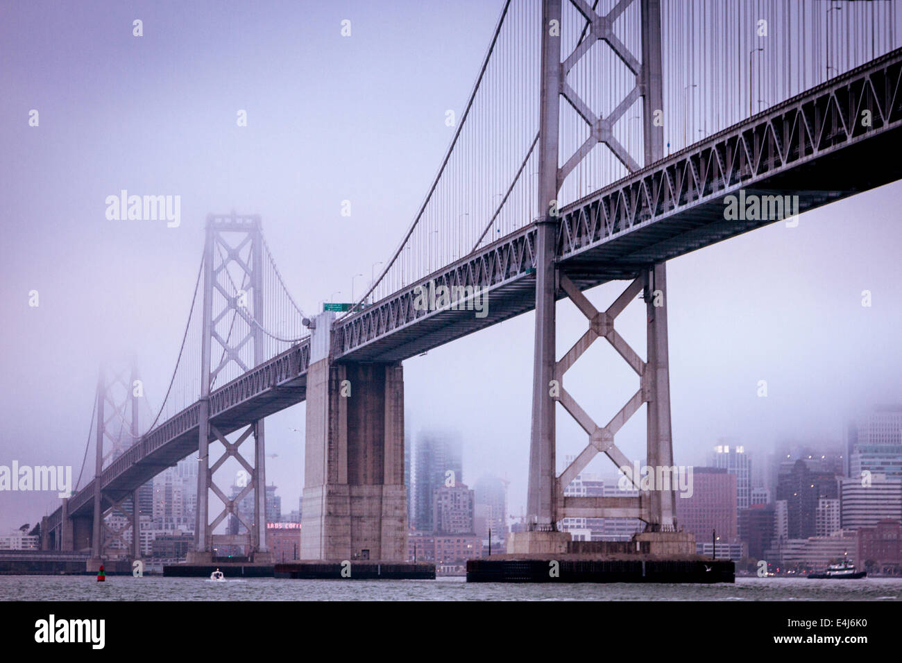 Bay Bridge in San Francisco und die Stadt aus dem Wasser an einem kalten und nebligen Tag Stockfoto