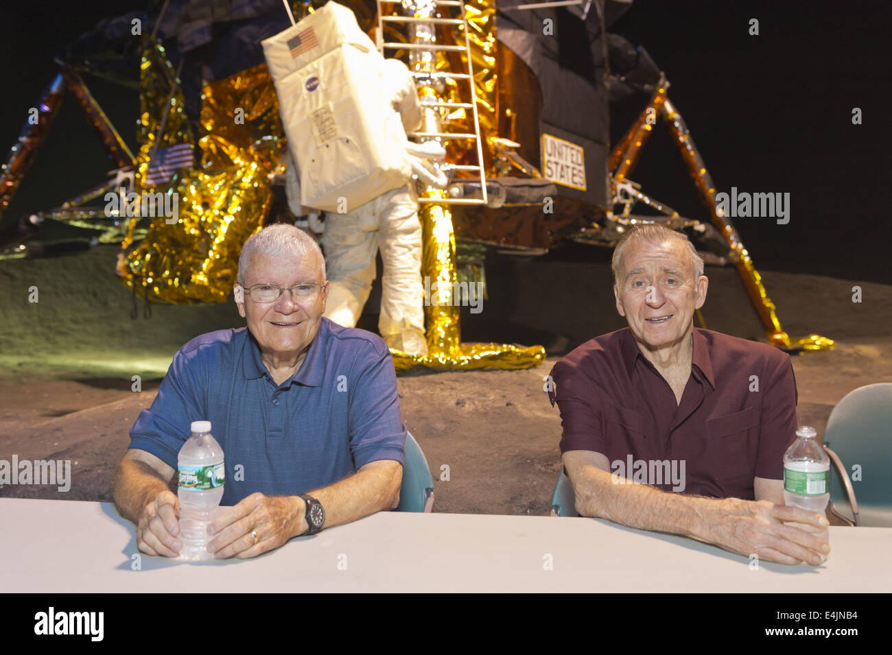 12. Juli 2014 - Garden City, New York, US - L-R, sind ehemalige NASA Apollo-Astronauten, FRED HAISE und WALTER CUNNINGHAM im Sommer 69 Feier im Long Island Cradle of Aviation Museum, auf der 45. Jahrestag der NASA Apollo 11 LEM, Ausflug Mondfähre, Landung auf dem Mond 20. Juli 1969 statt. Haise, der Pilot der Mondlandefähre Apollo 13-Mission und der Pilot der Mondlandefähre der Apollo 7 Mission Cunningham waren im LEM Raum während der Wiedervereinigung der ehemaligen Mitarbeiter von Northrop Grumman Aerospace Corporation. Dahinter steckt die Mondlandefähre LM-13 für Apollo 18 Mission zu Copern bestimmt Stockfoto