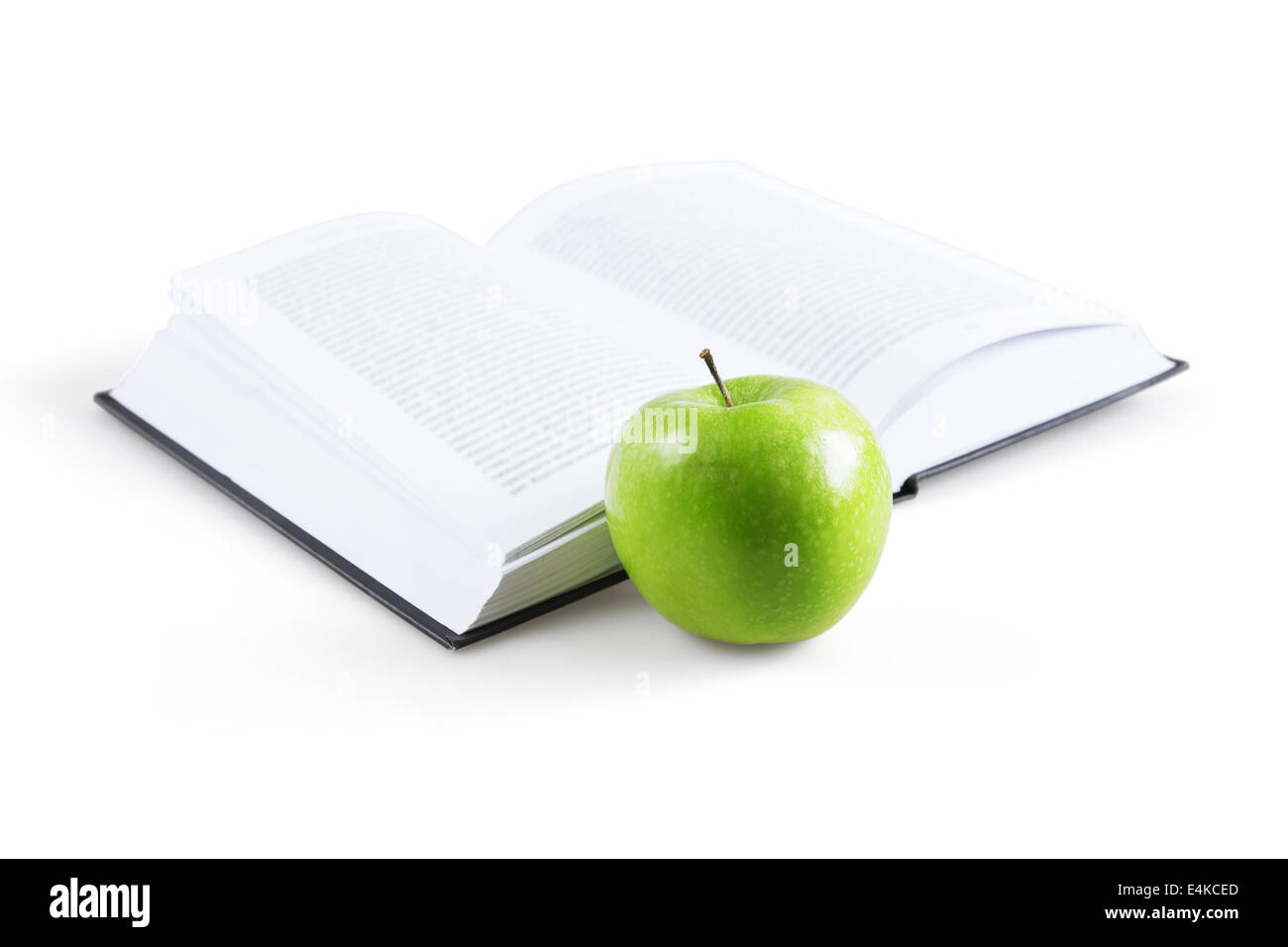Kunstbuch und reifer grüner Apfel Stockfoto