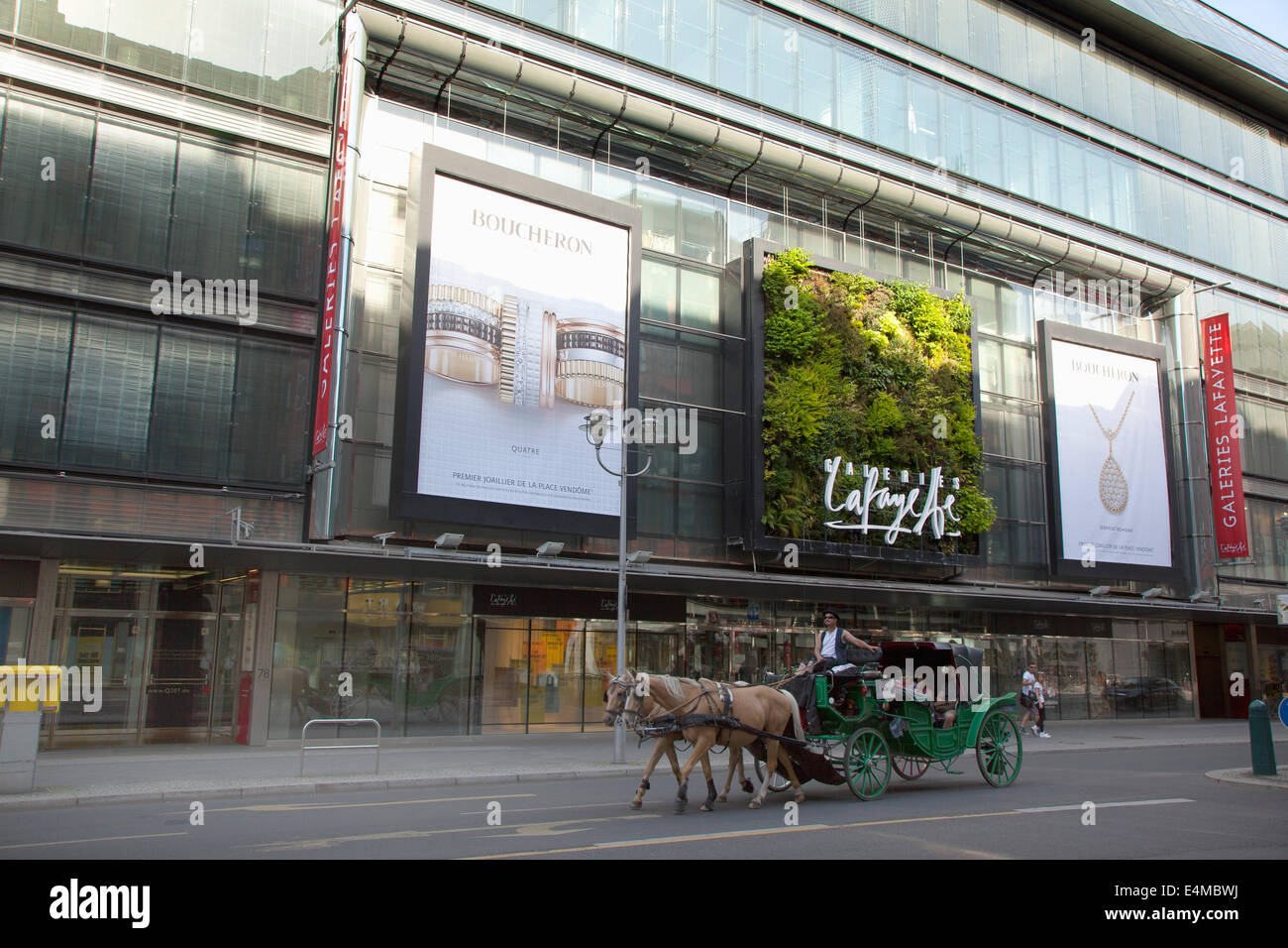 Deutschland, Berlin, Mitte, vertikale Pflanzung auf Außenseite der Galeries Lafayette in der Friedrichstraße mit Pferd & Kutsche vorbei. Stockfoto