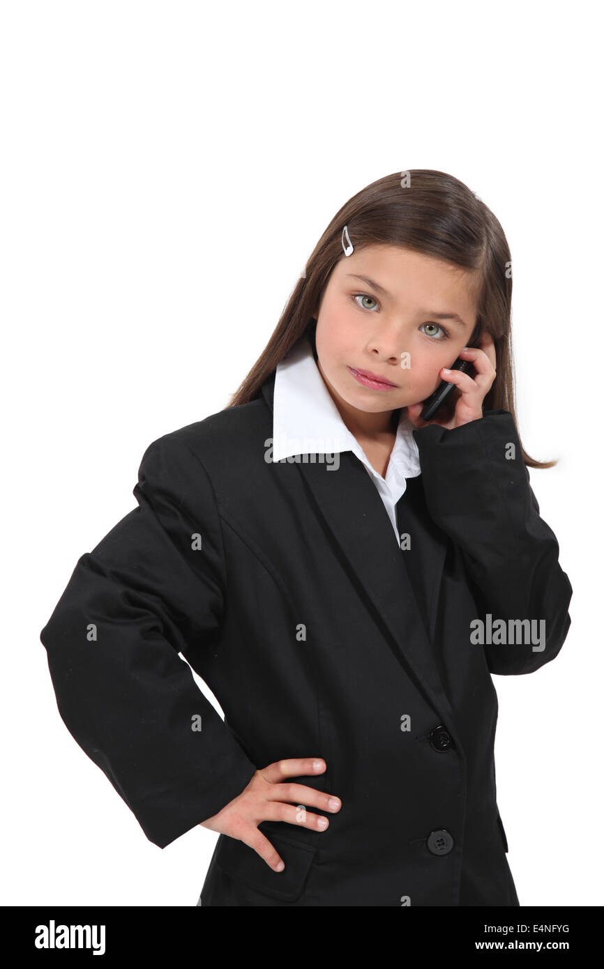 kleines Mädchen verkleidet als Geschäftsfrau Stockfoto