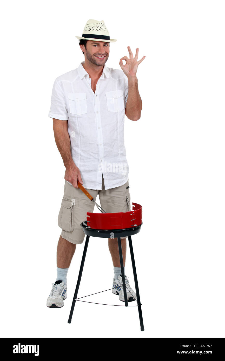 Mann stand auf Grill kochen Stockfoto