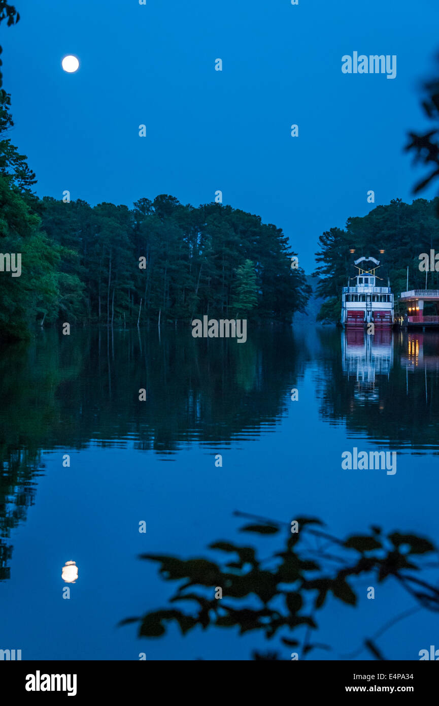 Ein Vollmond steigt über einen noch See und der Henry W. Grady Schaufelrad Riverboat im Stone Mountain Park in Atlanta, Georgia. Stockfoto