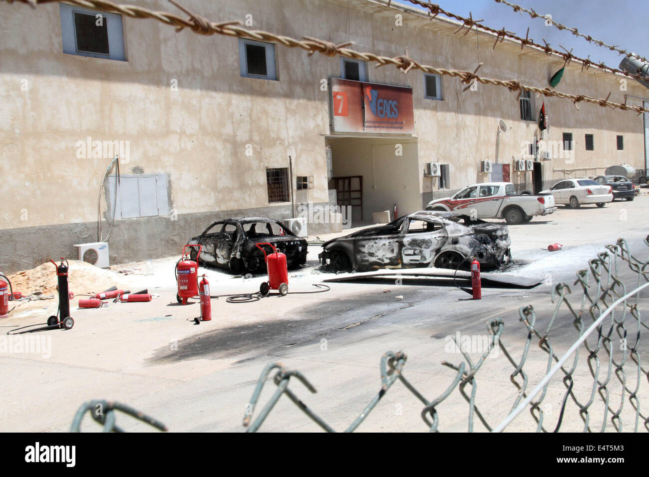 Tripolis. 16. Juli 2014. Das Foto, aufgenommen am 16. Juli 2014 zeigt einige zerstörte Autos in Tripoli International Airport, in Libyen. Internationale Flughafen Libyens Hauptstadt Tripolis wurde unter Angriff am Mittwoch mit die Zahl der Todesopfer erreichen 30, laut Sicherheitsquellen erneuert. Bildnachweis: Hamza Türkei/Xinhua/Alamy Live-Nachrichten Stockfoto