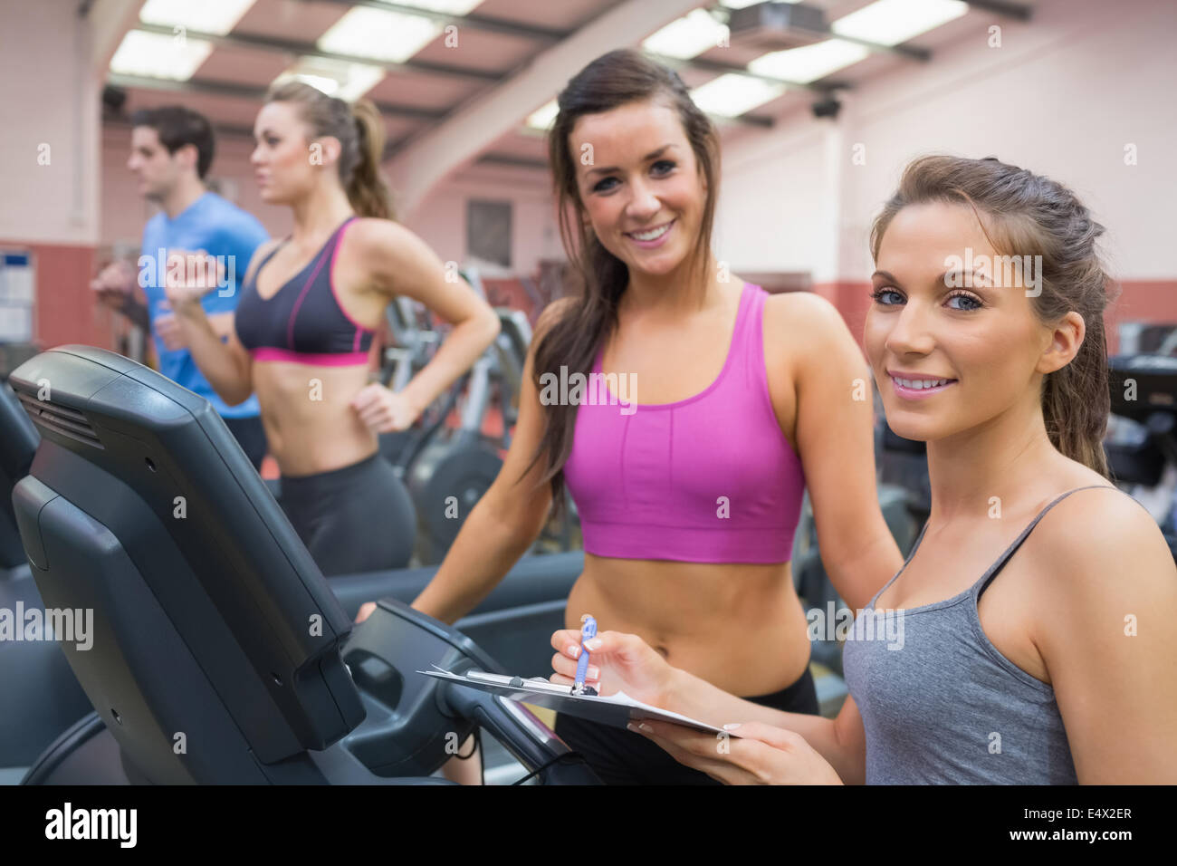 Glückliche Frauen in der Turnhalle während der Bewertung Stockfoto