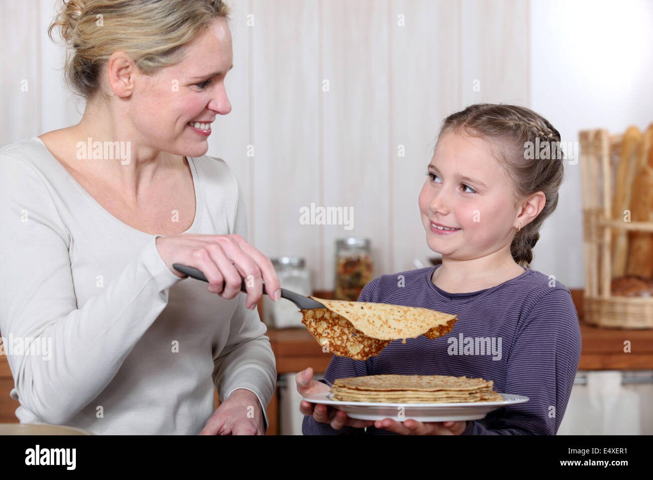Eine Mutter Kochen Pfannkuchen mit ihrer Tochter. Stockfoto