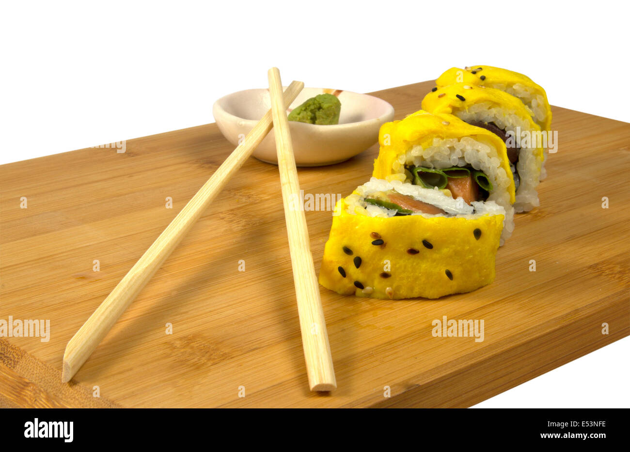 Sushi mit Thunfisch und Rührei auf einem Holztablett mit Ess-Stäbchen und wasabi Stockfoto