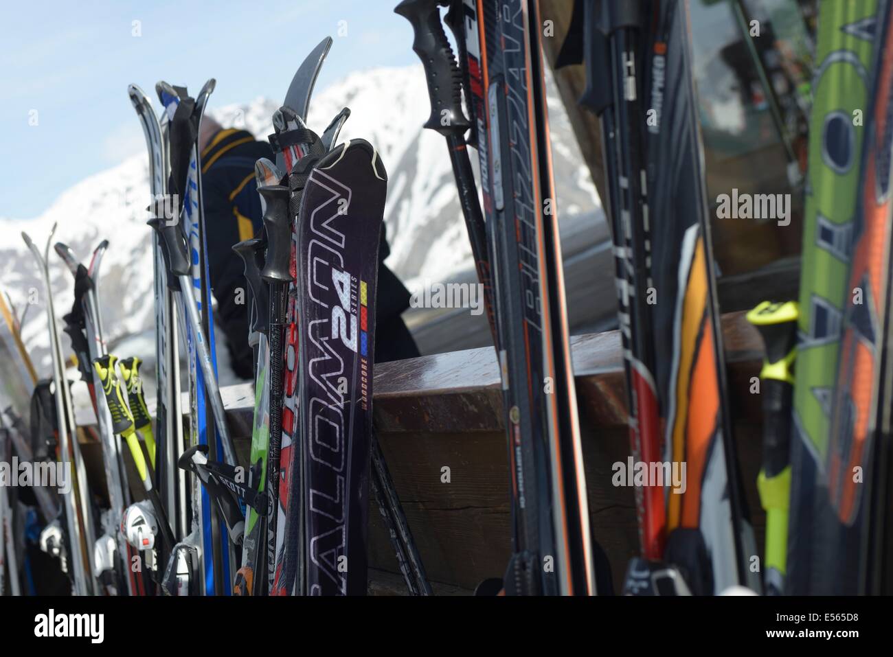 Skier und Skistöcke gestapelt auf einem Ständer außerhalb einer der vielen Tavernen Après-Ski in den Bergen von Livigno Italien Stockfoto