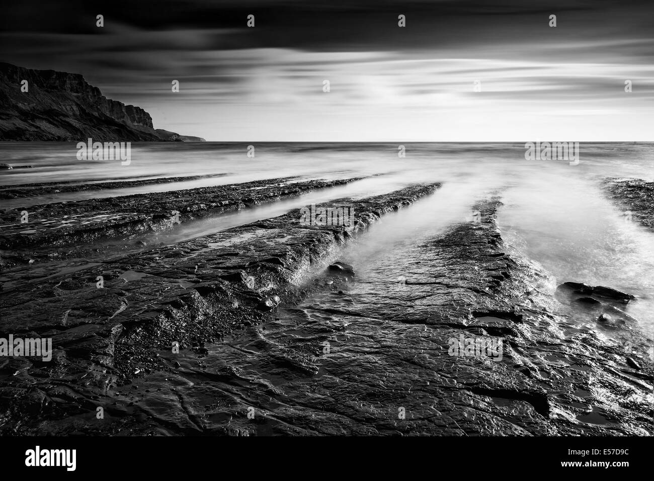 Atemberaubende Küste der schwarzen und weißen Seenlandschaft und felsige Ufer bei Sonnenuntergang Stockfoto