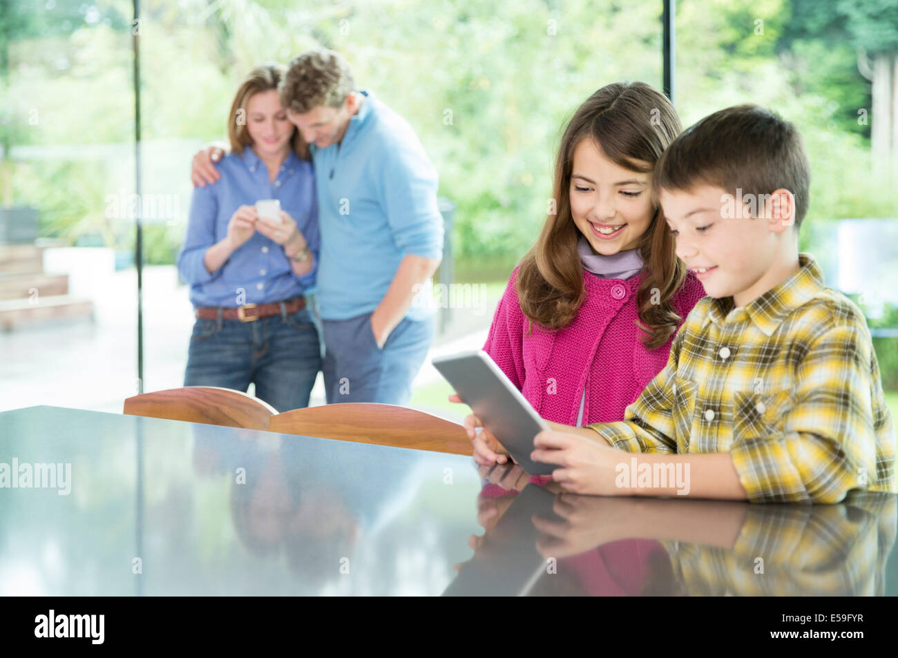 Familie mit Hilfe von Technologie in Küche Stockfoto