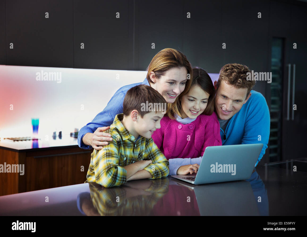 Familie mit Laptop zusammen in der Küche Stockfoto