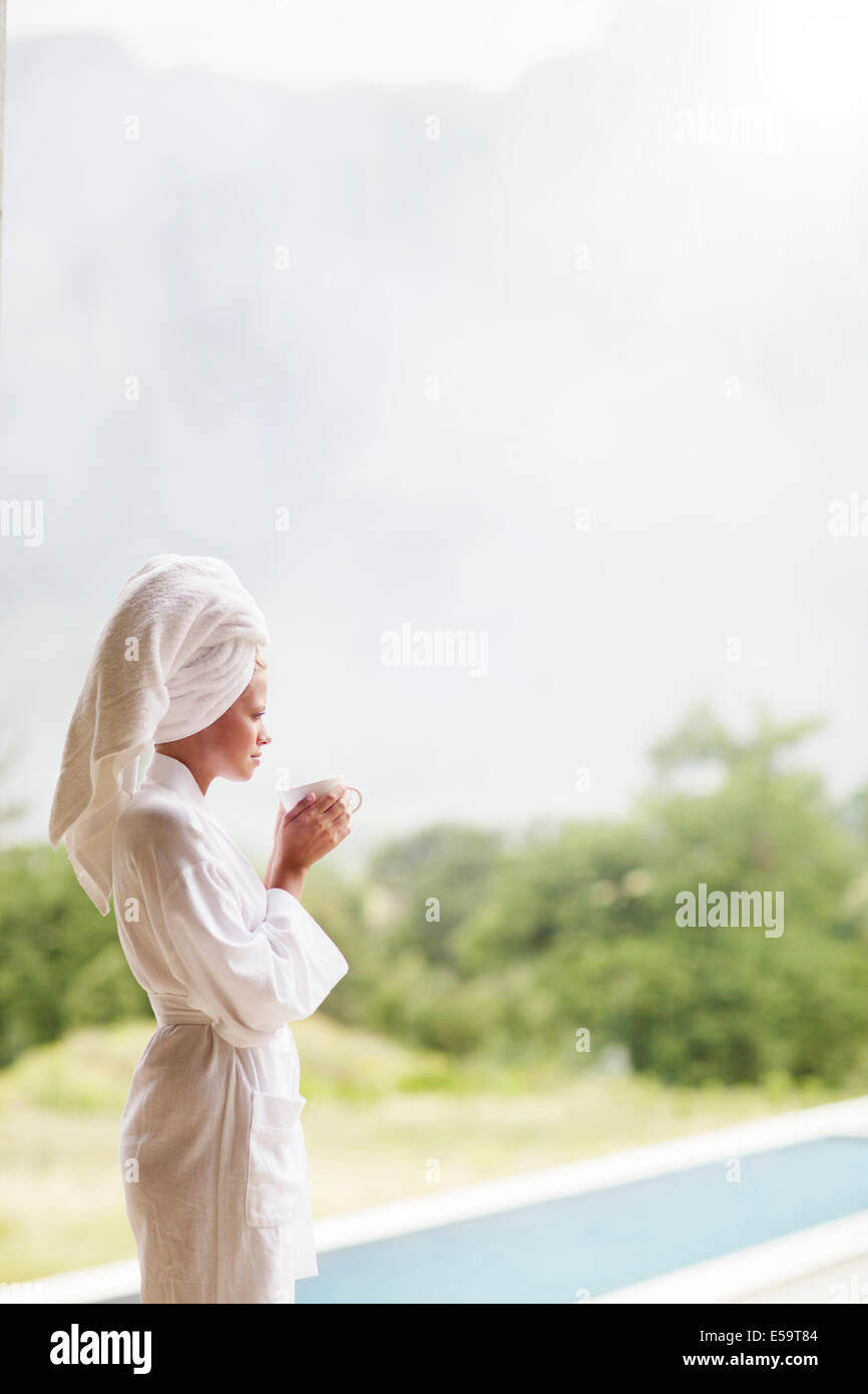 Frau im Bademantel Kaffeetrinken im freien Stockfoto