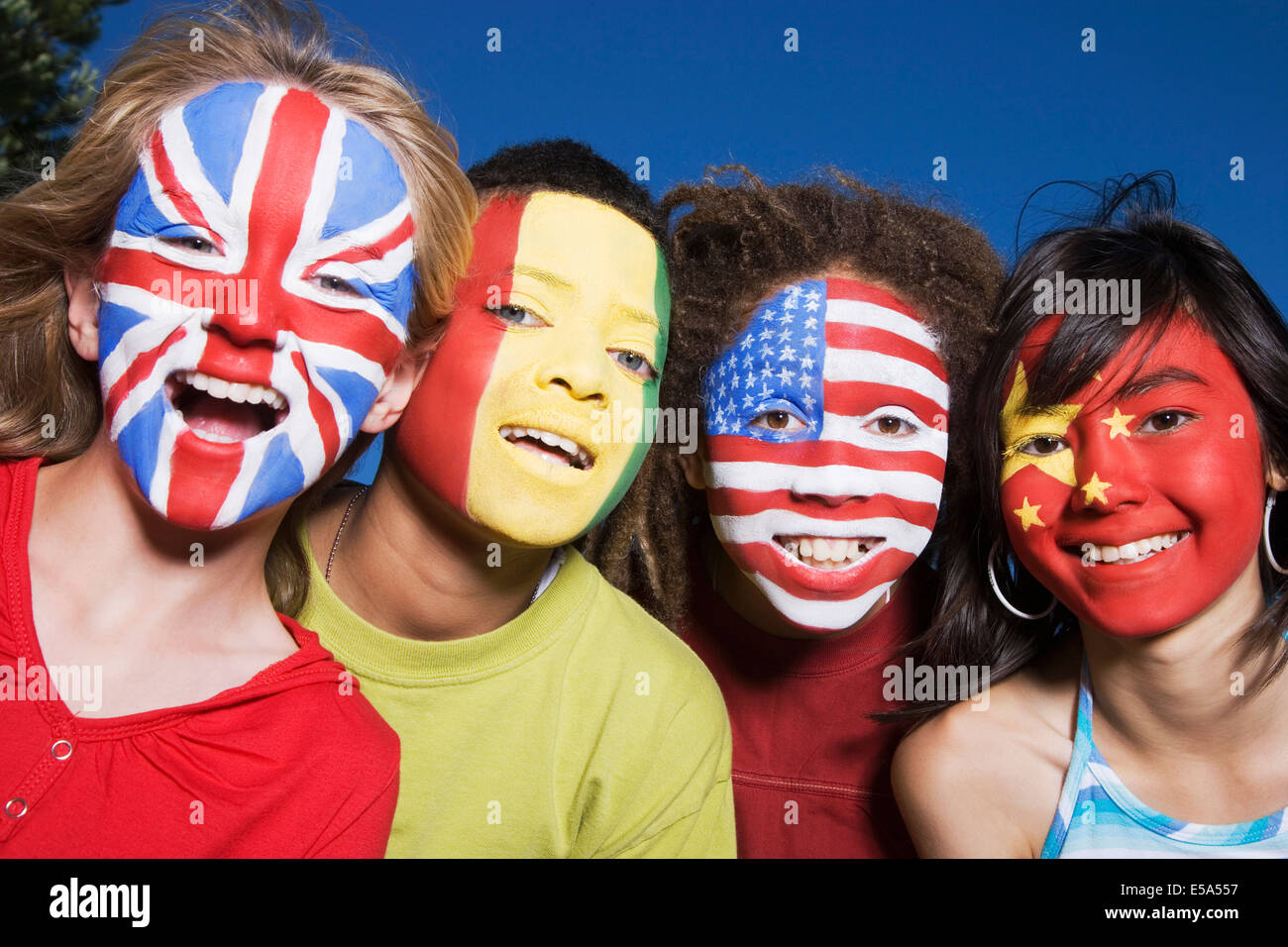 Kinder mit Großbritannien, Guinea, USA und chinesische Fahnen auf Gesichter gemalt Stockfoto