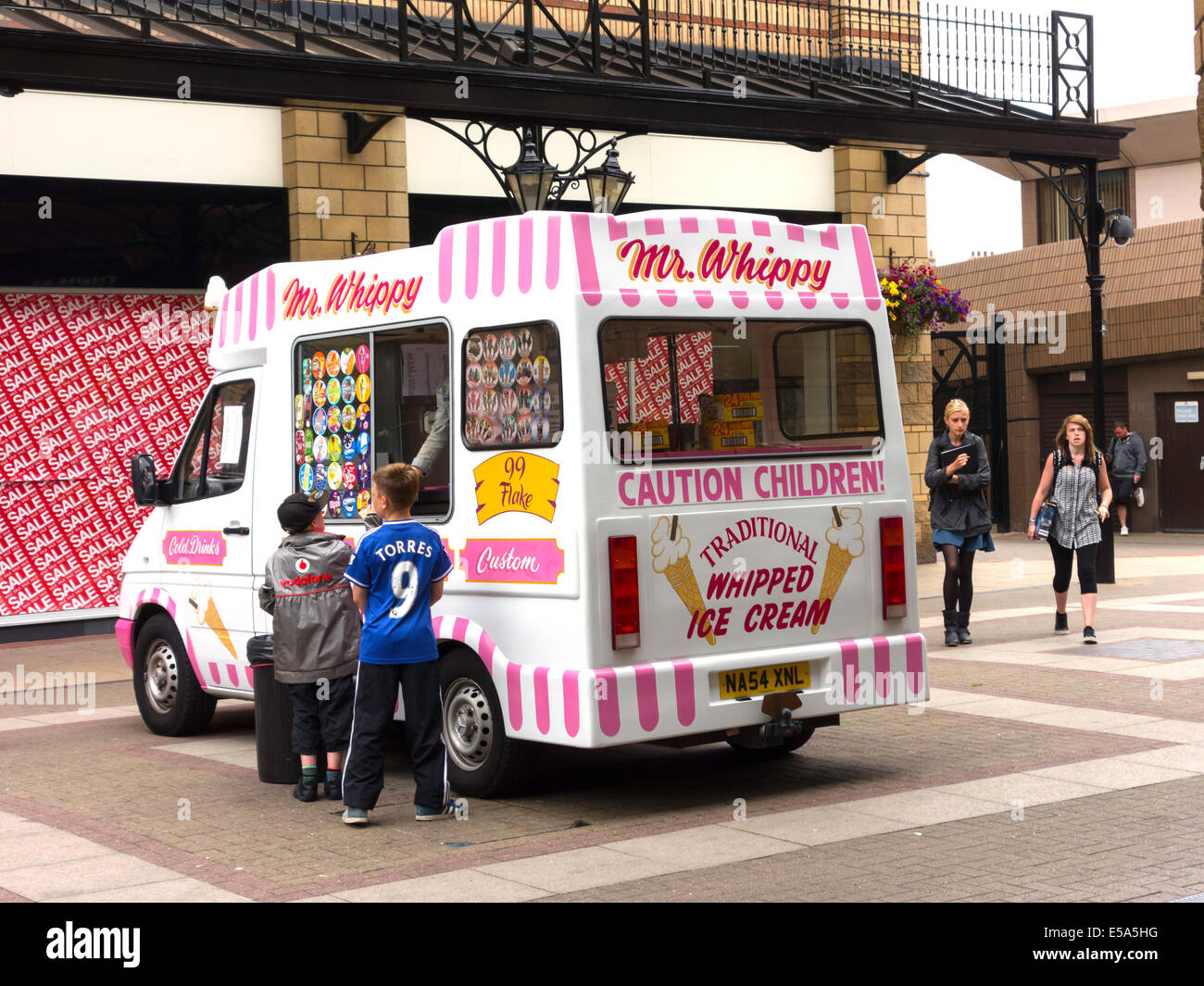 Jungs kaufen Eis von einem traditionellen Herr Whippy van in Captain Cook Square Middlesbrough Stockfoto