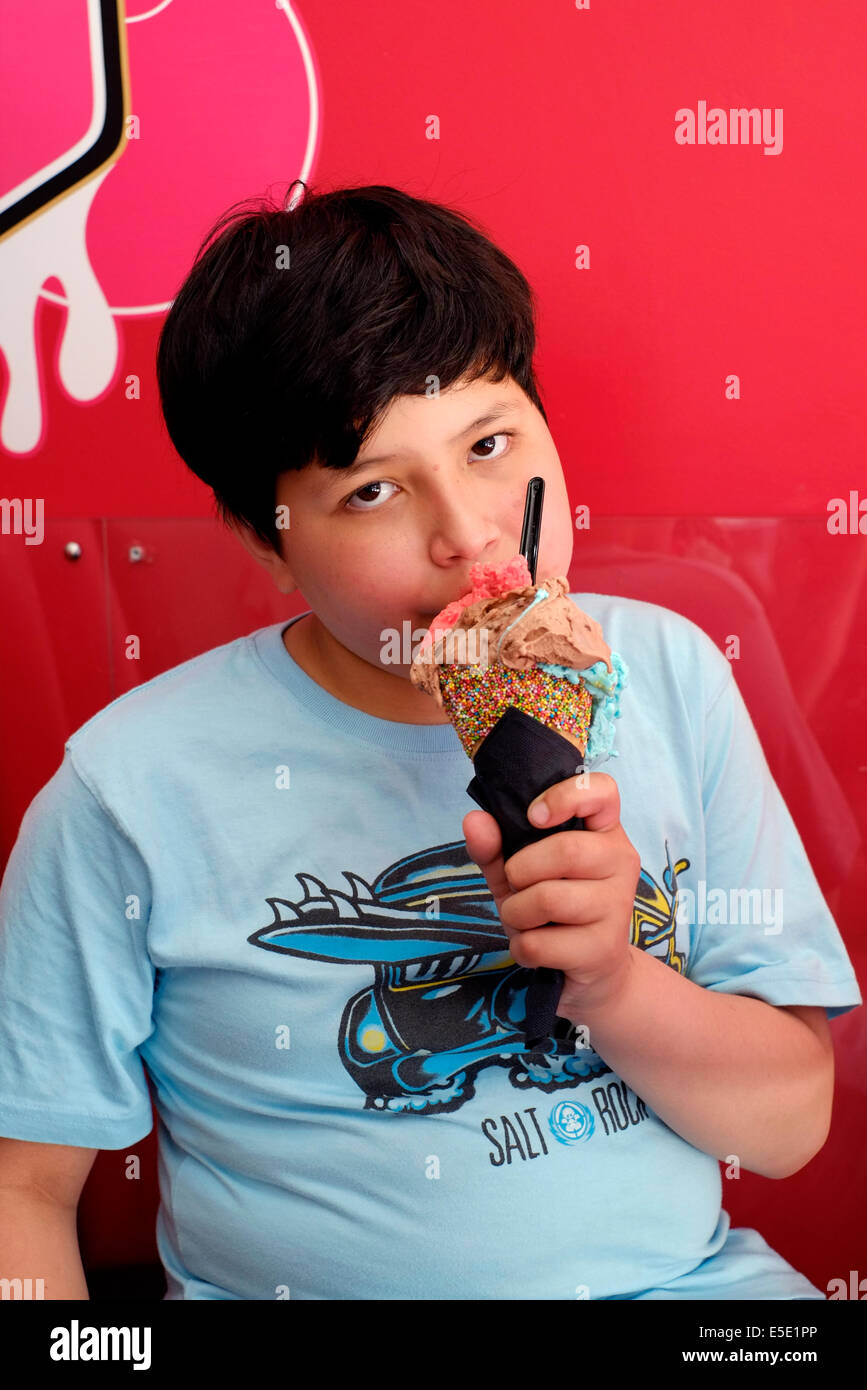 kleiner Junge elf Jahre alt genießen Sie Eis in Kugeln Eis Eisdiele Southsea uk Stockfoto