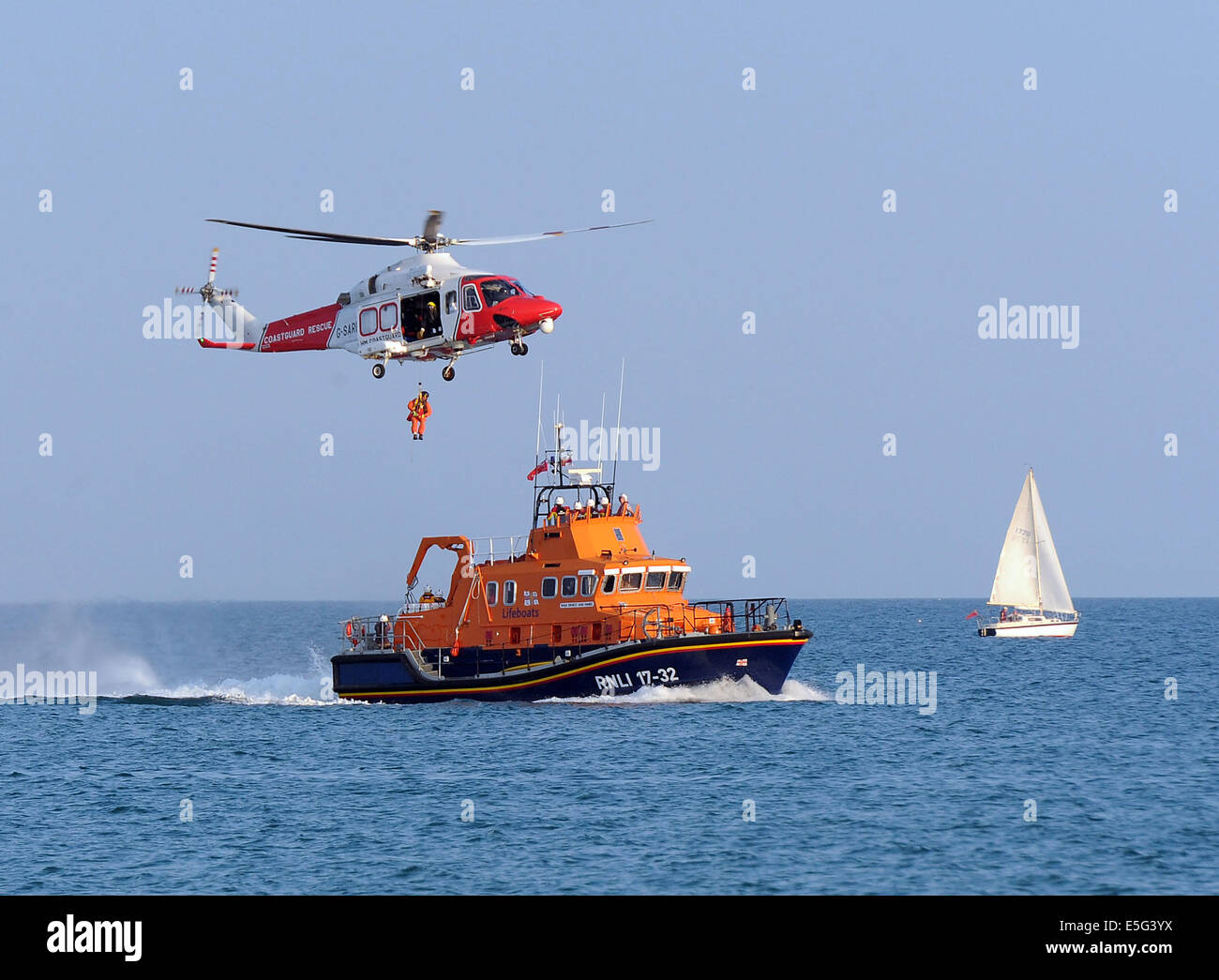 Küstenwache-Search and Rescue Helikopter, Winde Mann und RNLI-Rettungsboot, England, UK Stockfoto