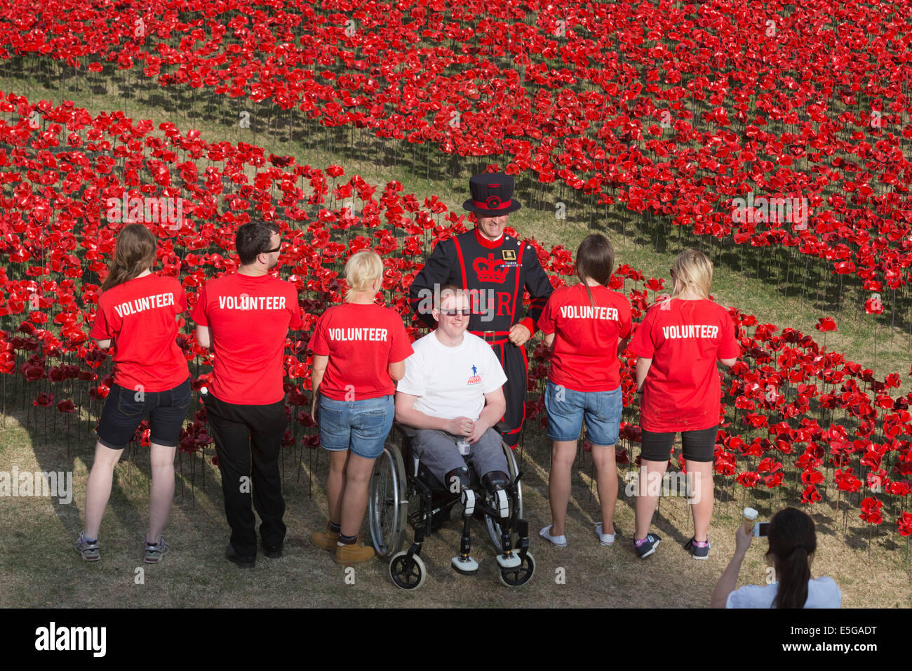 London, UK. 30. Juli 2014. Im Bild: Anthony Cooper, einen doppelten Amputierte Soldaten, die in der Provinz Helmand im Jahr 2010 mit anderen Freiwilligen gedient. Ein Feld von Keramik Mohn wird von Freiwilligen in den Wassergraben des Tower of London gepflanzt. Es wird schließlich bestehen aus 888.246 Mohn, jeweils ein britischer oder Kolonialsoldaten während des ersten Weltkrieges gefallen. Bildnachweis: Nick Savage/Alamy Live-Nachrichten Stockfoto