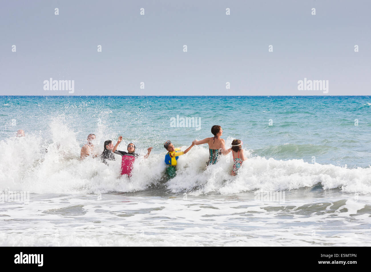 PATARA-Strand, Türkei Exodus Familiengruppe in Wellen am Strand von Patara. Stockfoto