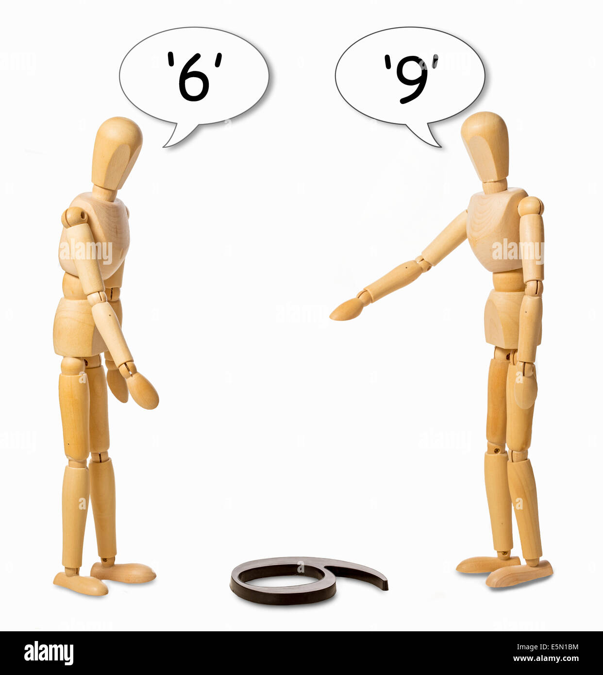 zwei Männerken streiten, ob eine Zahl auf dem Boden ein 6 oder 9 ist Stockfoto