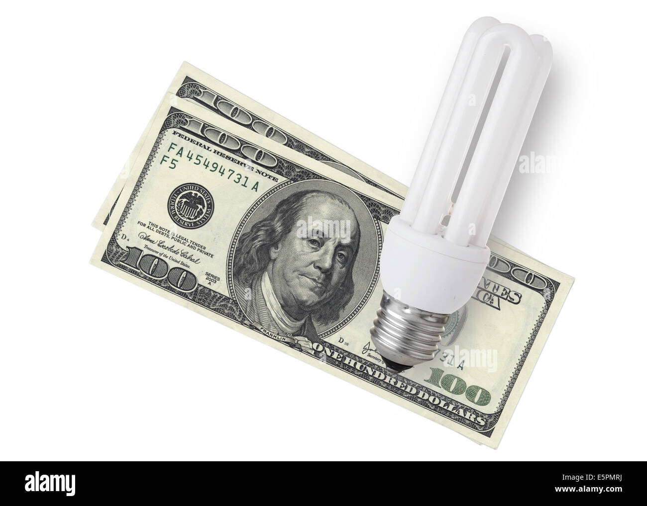 Enegy Saver Glühlampe über Dollarnoten auf weißem Hintergrund Stockfoto
