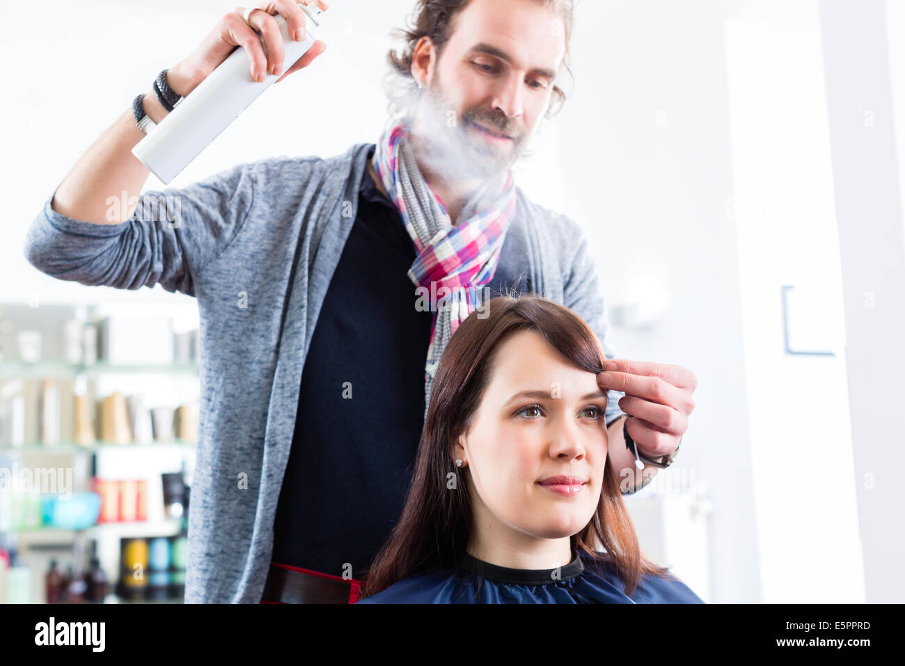 Männliche Coiffeur geben Frauen Hairstyling mit Haarspray im shop Stockfoto