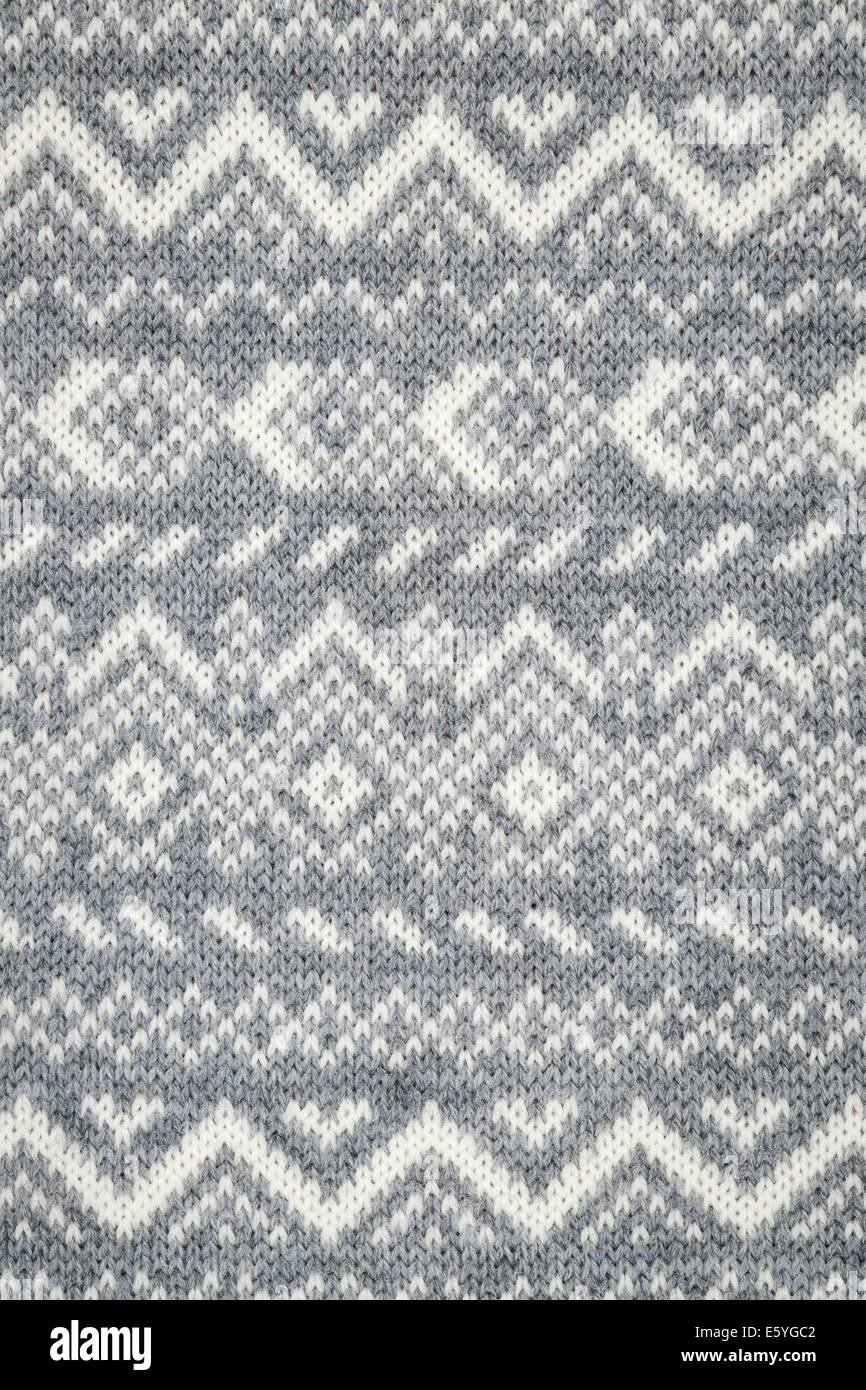 Stricken Sie Textilhintergrund mit grauen und weißen geometrische Strickmuster Stockfoto