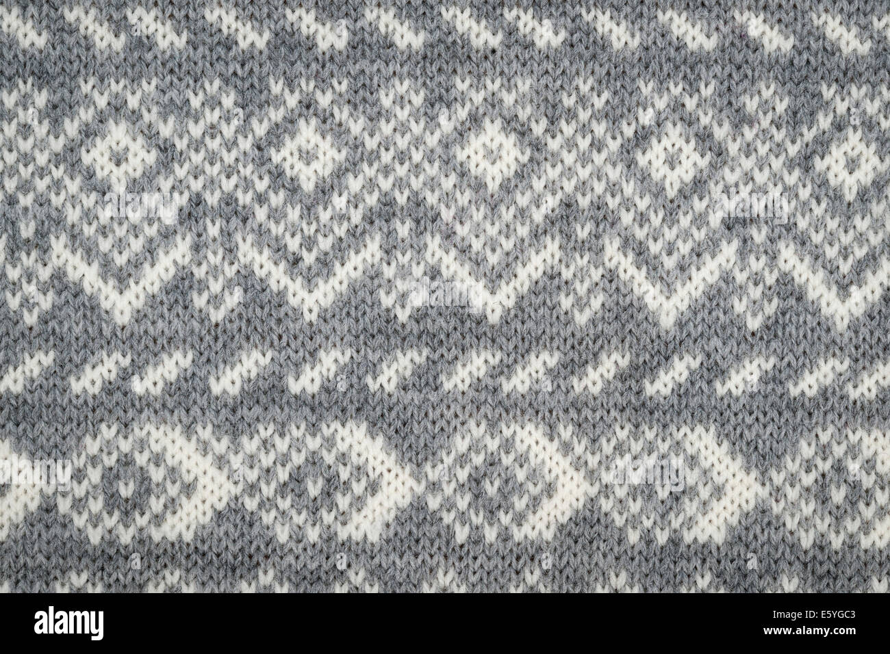 Nahaufnahme von Strick-Hintergrund mit grauen und weißen geometrische Strickmuster Stockfoto