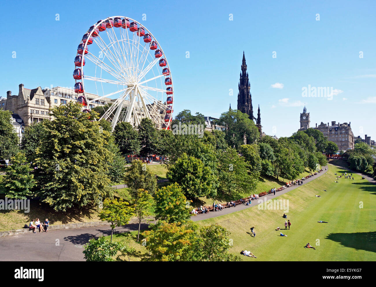 Ferris Big Festival Rad & Scott Monument am East Princes Street Gardens Edinburgh Schottland mit Besuchern, die Sonne zu genießen Stockfoto
