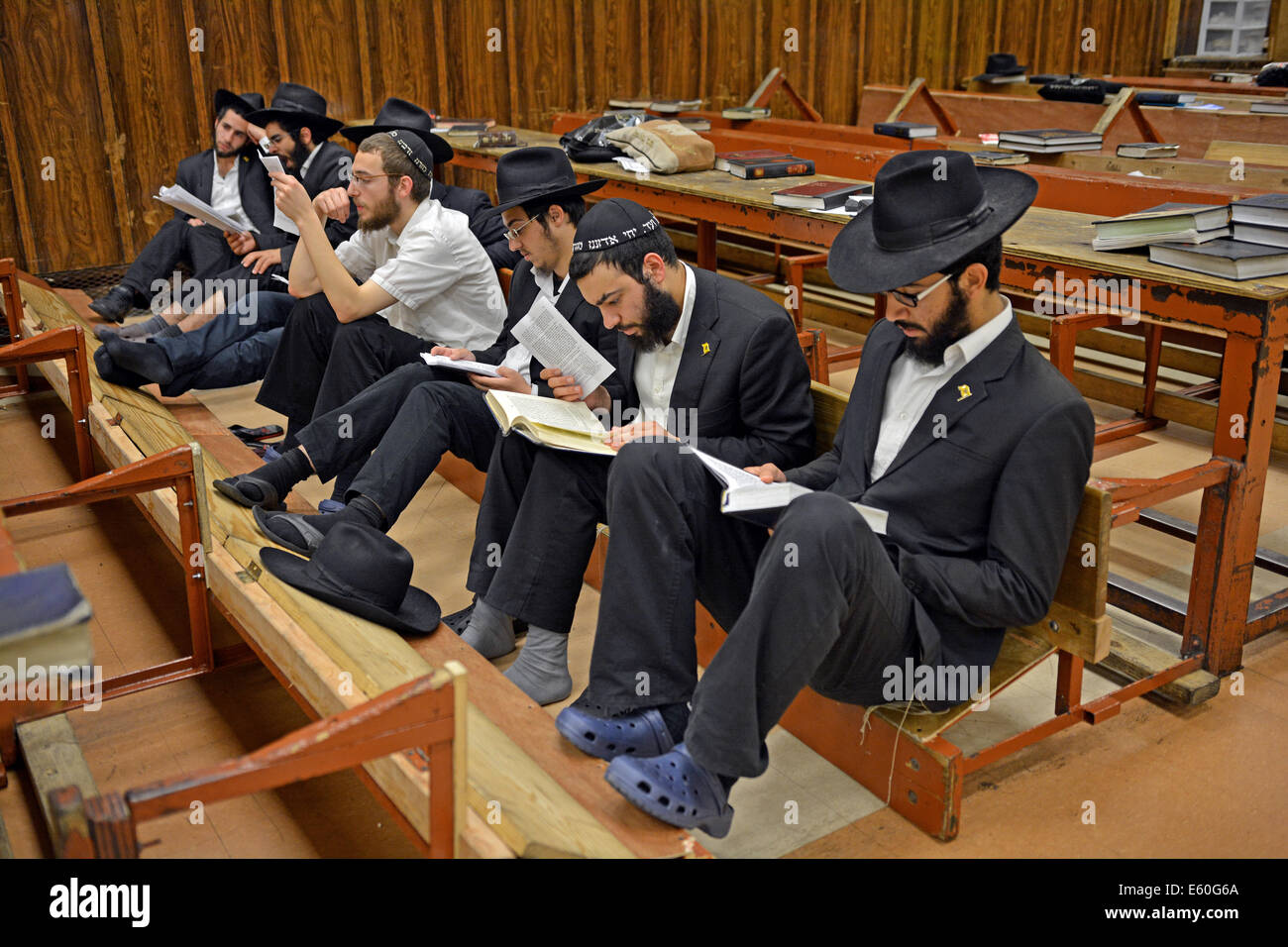 Junge religiöse jüdische Männer beten während Tisha B'Av Dienste in einer Synagoge in Brooklyn, New York, USA Stockfoto