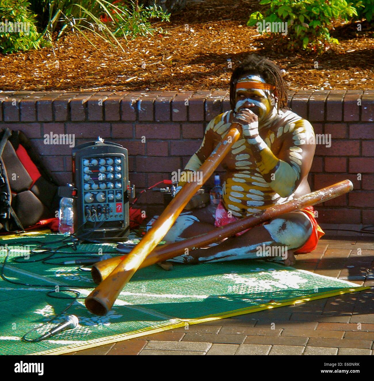 Ein Aborigine Mann spielt Didgeridoo für Touristen in Circular Quay, Sydney, Australien Stockfoto