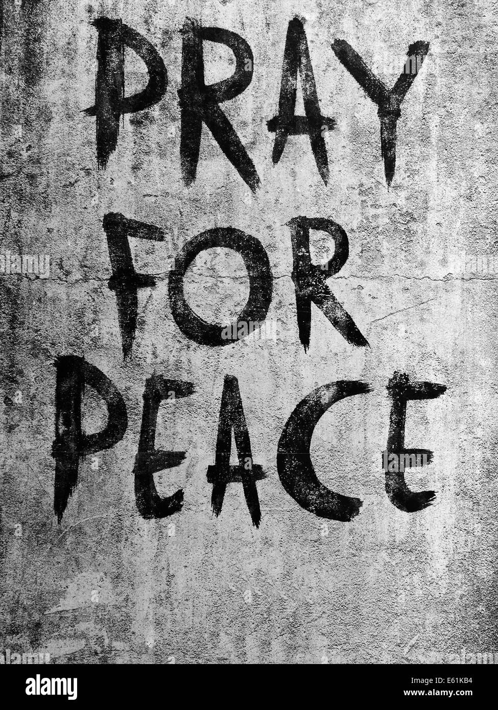 Beten Sie für Frieden Nachricht an Wand Stockfoto