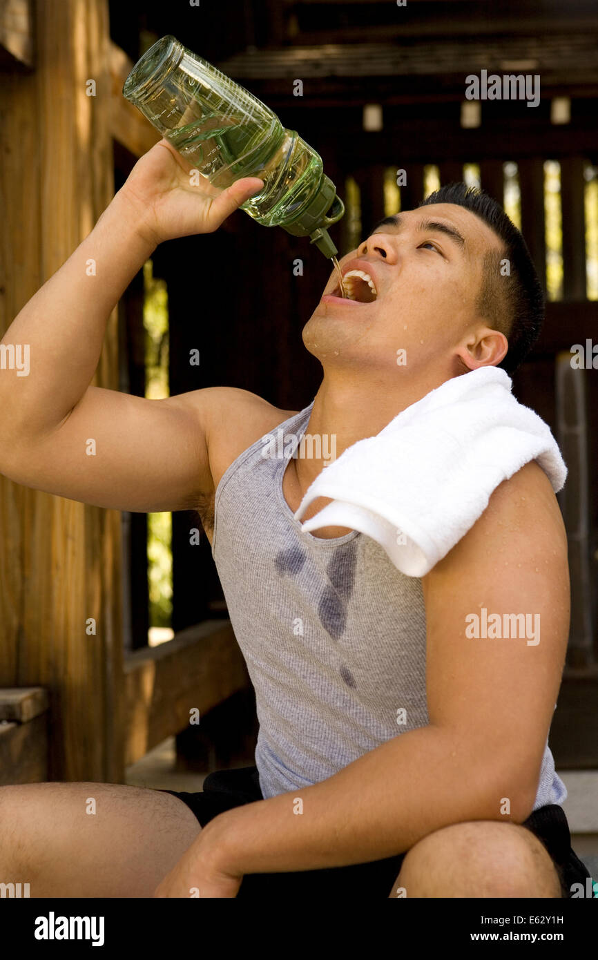 Junge asiatische Menschen Trinkwasser Stockfoto
