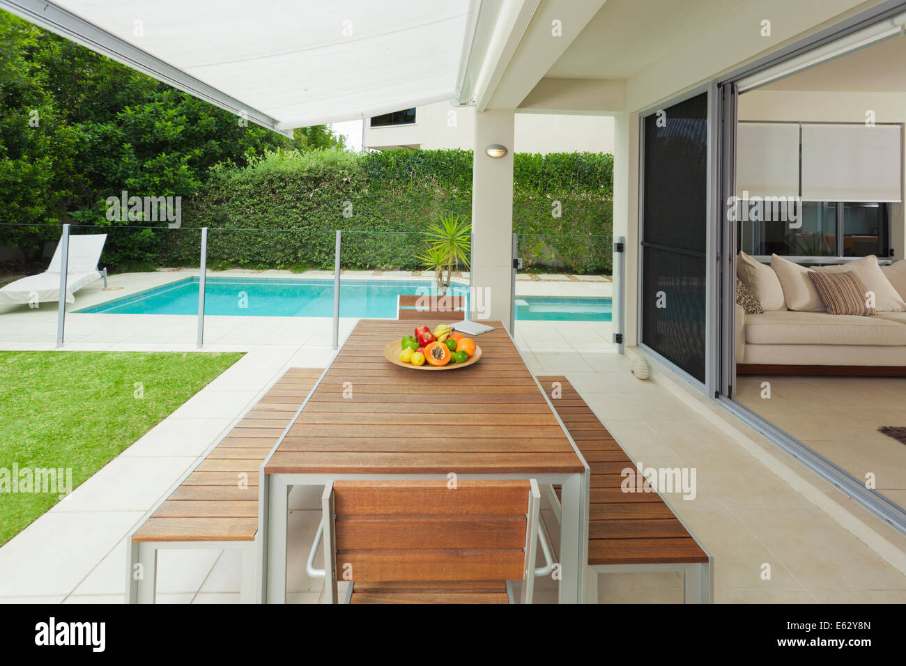 Moderne s Garten und Wohnzimmer mit Swimming Pool und Tischdekoration Stockfoto