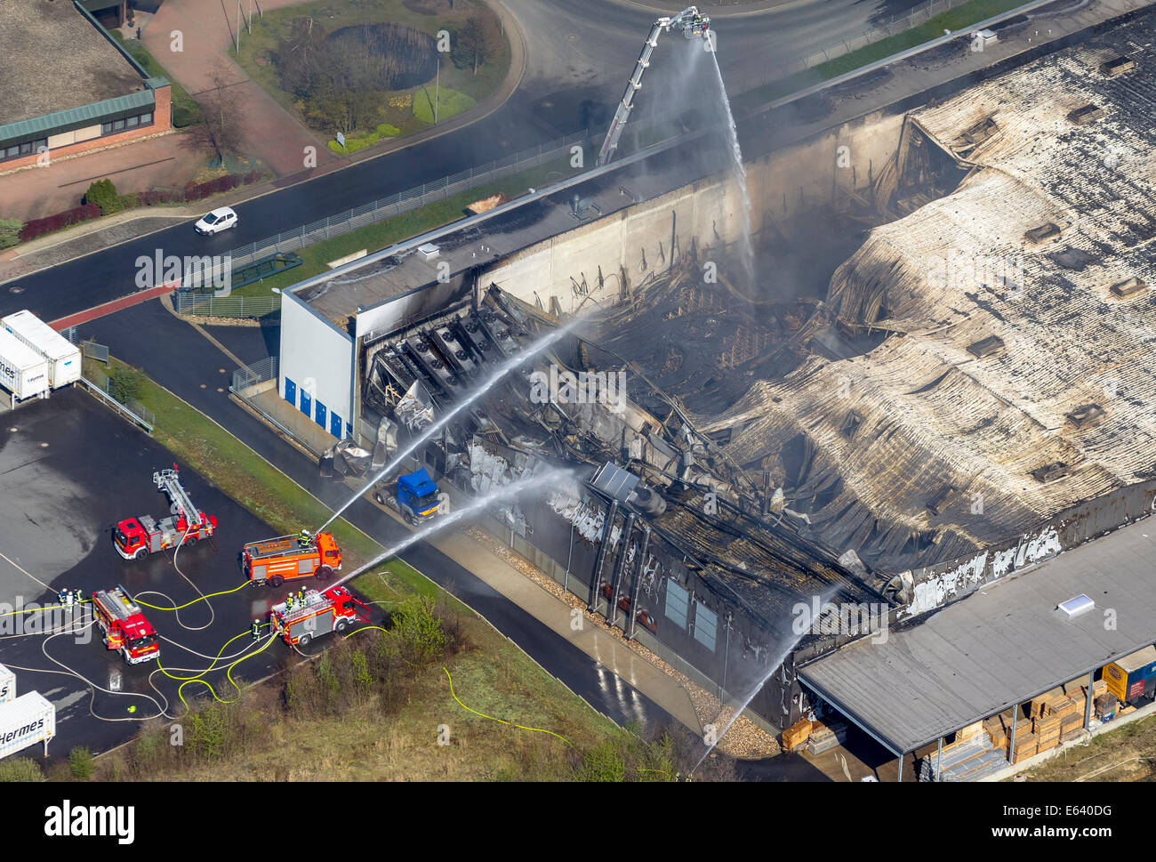 Luftaufnahme, Feuer Feuerwehr kämpfen eine große Zerstörung einer Fabrik Gebäude von WKW Automotive Stockfoto
