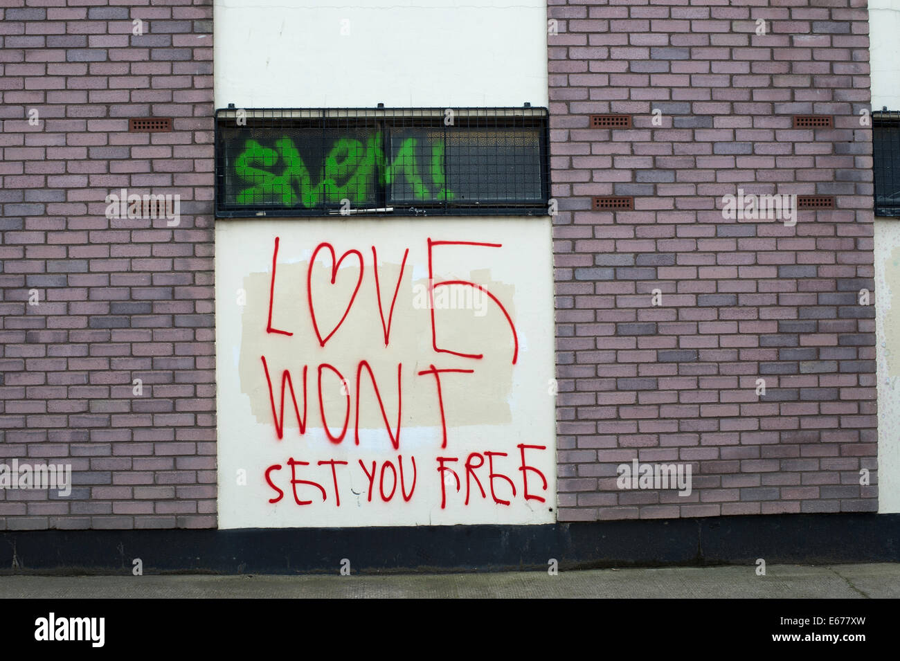 Hackney Wick - Graffiti "Liebe euch frei machen wird nicht" zu sagen. Stockfoto