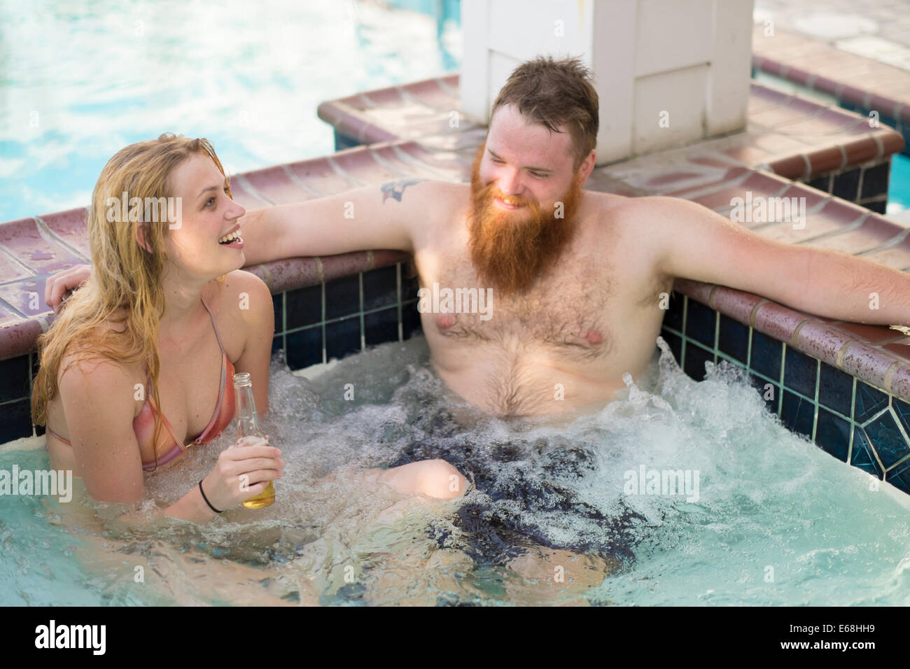 Whirlpool im Wellnessbereich des Hotels mit jungen Erwachsenen Bier tranken und lachten. Stockfoto