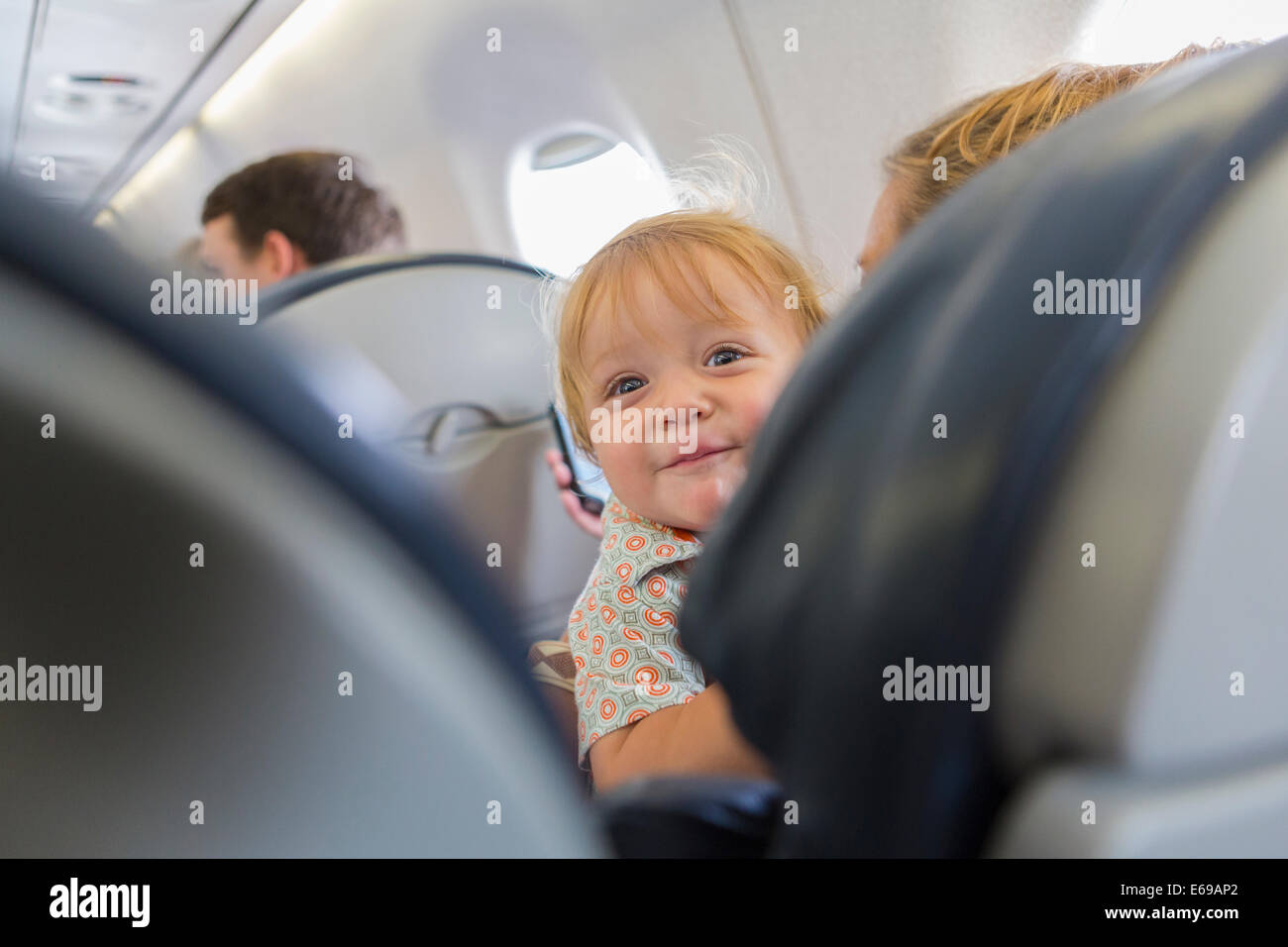 Kaukasische Baby Lachen auf Flugzeug Stockfoto