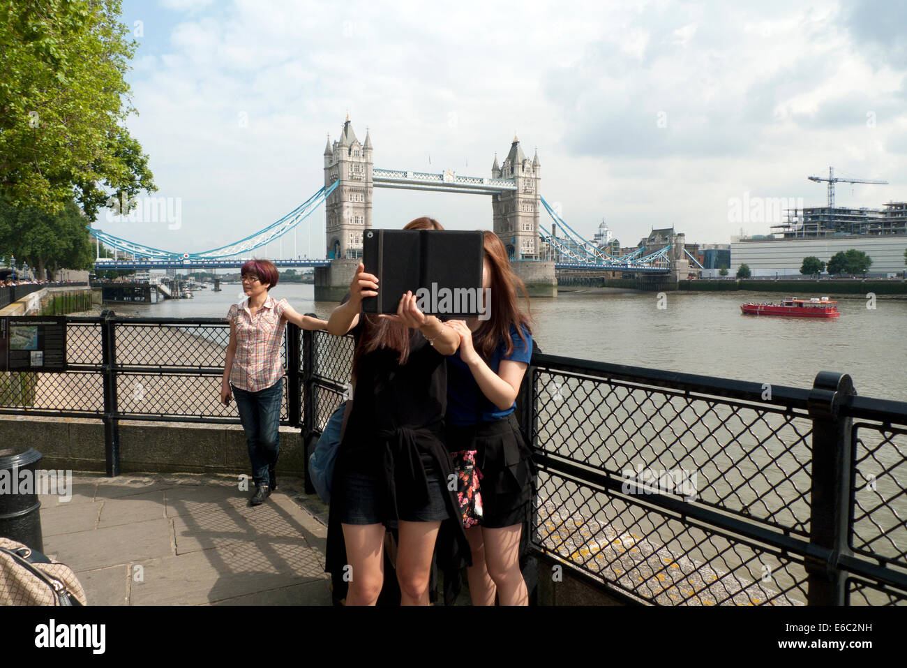 Junge asiatische Frauen Selfie-Aufnahme mit dem Ipad auf Tower Bridge London UK KATHY DEWITT Stockfoto