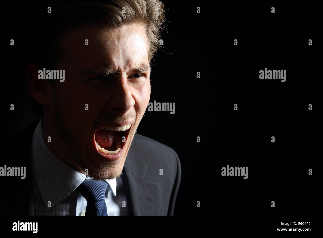 Wütend Geschäftsmann schreien in einem schwarzen Hintergrund isoliert Stockfoto