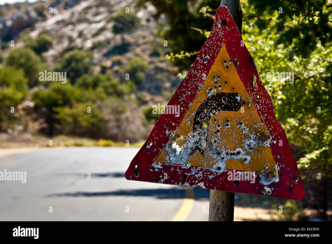 Straßenschild voller Einschusslöcher in Kreta, Griechenland. Stockfoto
