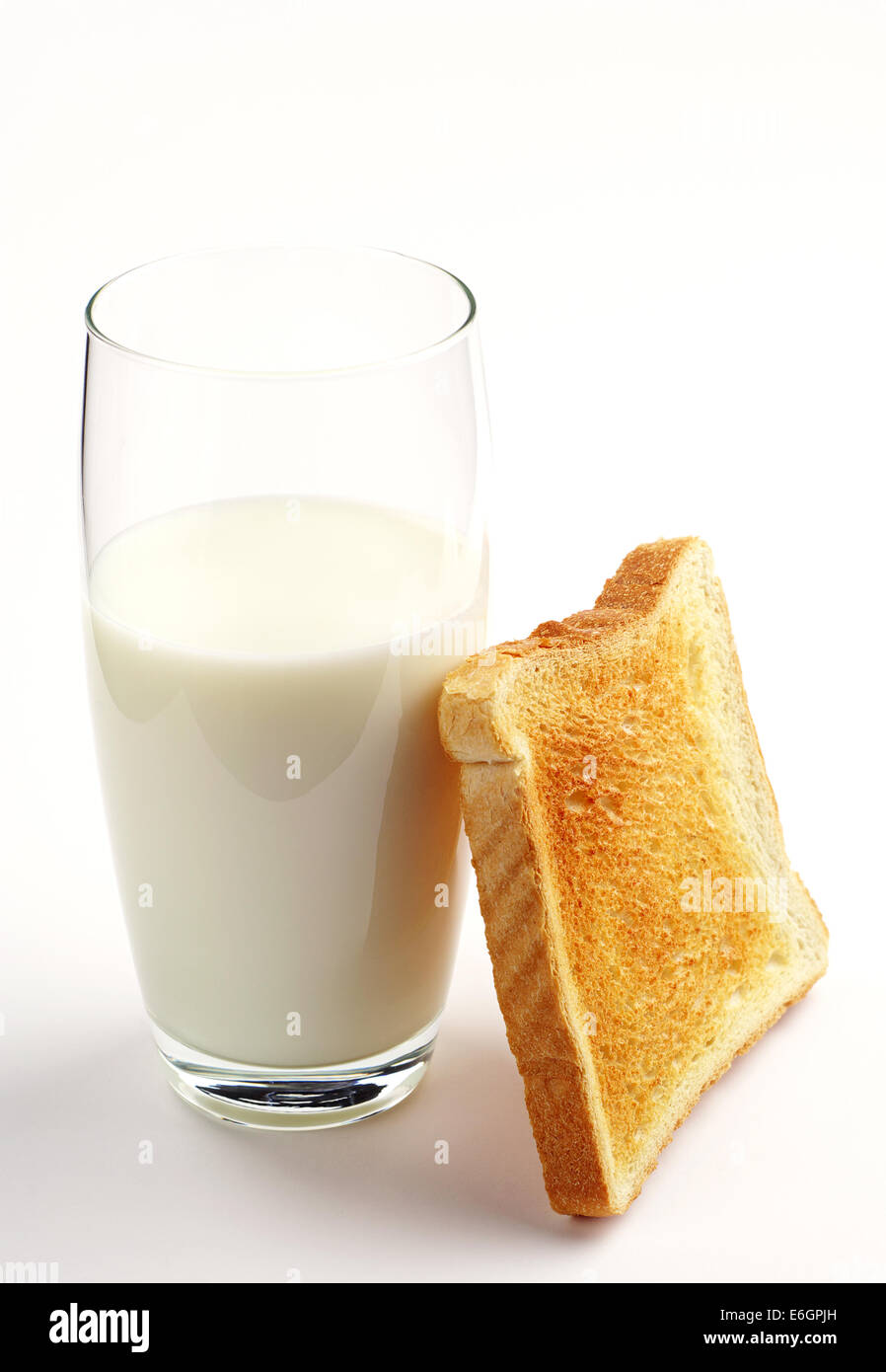 Glas Milch und Toast Brot auf weißem Hintergrund Stockfoto