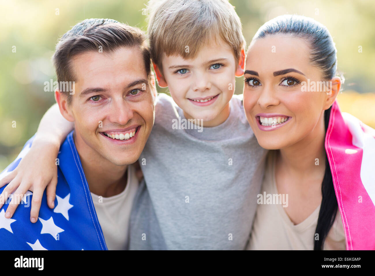 schöne amerikanische Familie mit uns Flagge im Freien am 4. Juli Stockfoto