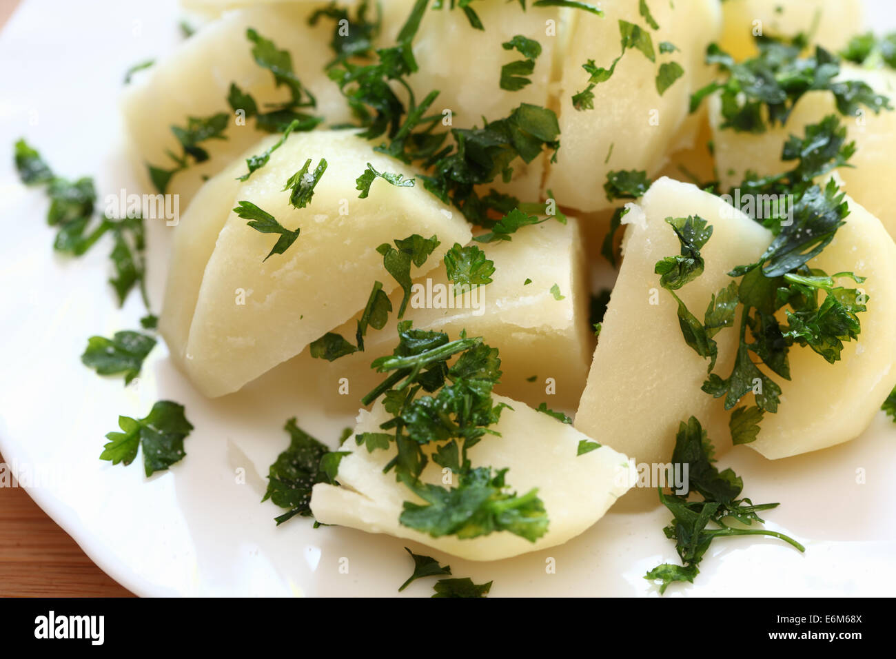 Gekochte Kartoffeln mit Petersilie auf einem Teller. Closeup. Stockfoto