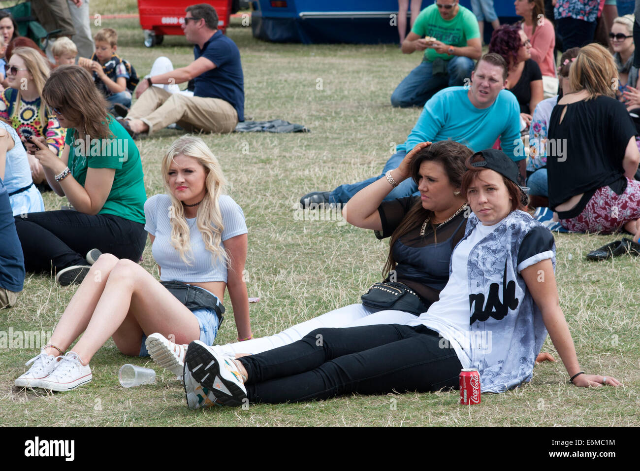 Menschenmengen saßen auf dem Rasen genießen Sie eine Aufführung in der siegreichen Festival 2014 Southsea England uk Stockfoto