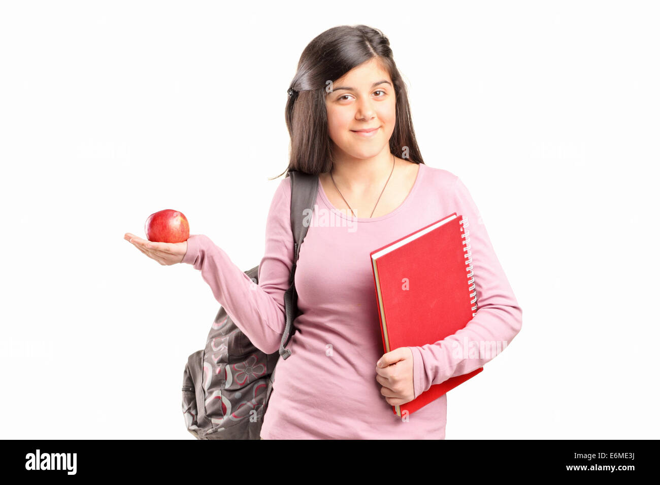 Schulmädchen hält einen Apfel auf weißen Hintergrund isoliert Stockfoto