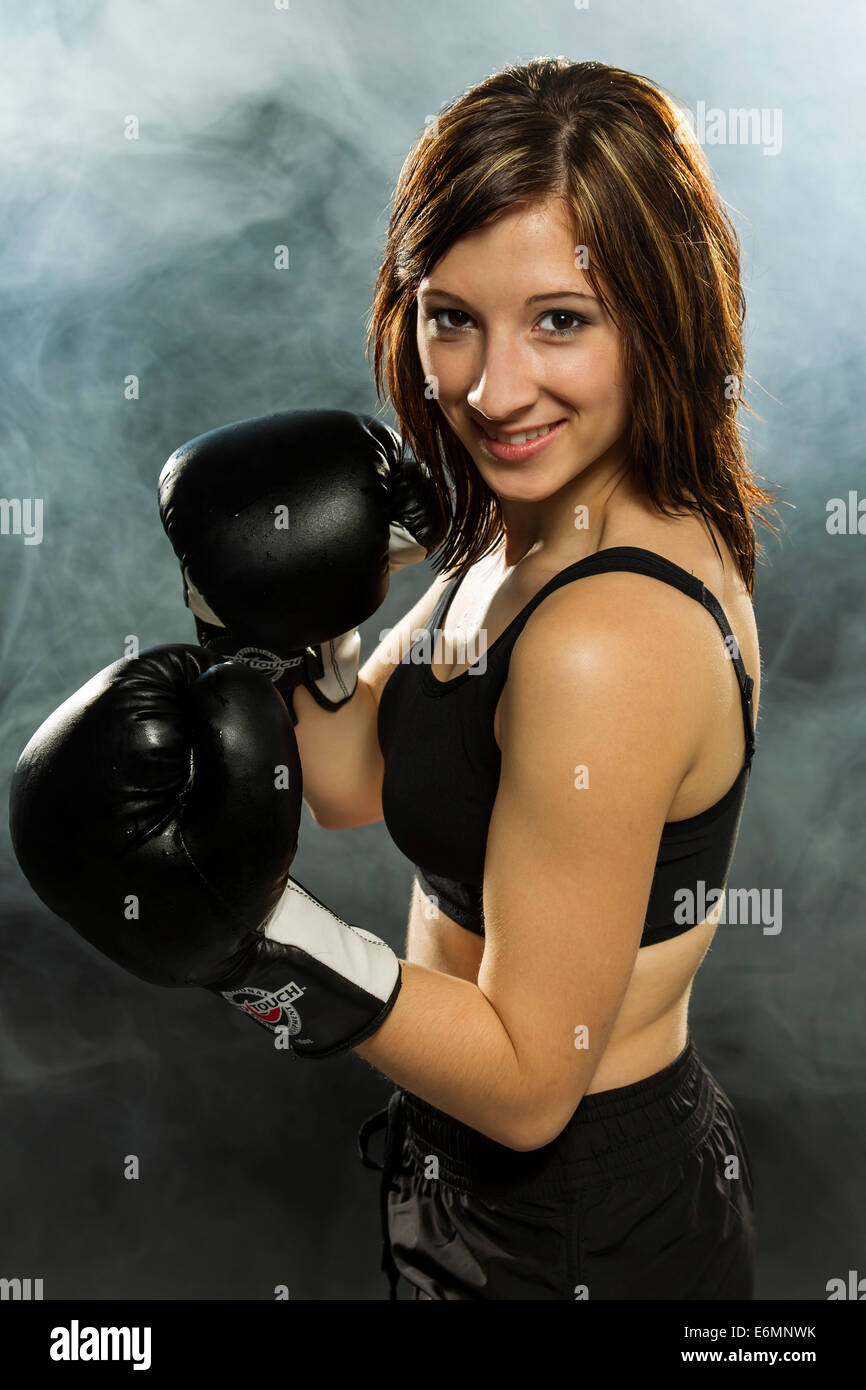Junge Frau trägt Sportbekleidung und Boxhandschuhe Stockfoto