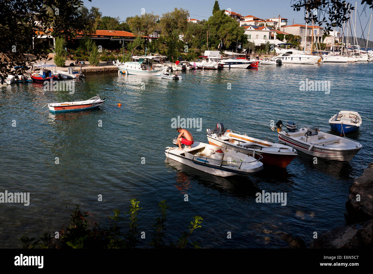 Ein Mann versucht, den Motor seines Bootes im Hafen Dorf der Steni Vala in Alonnisos, Griechenland am August 2014 starten. Stockfoto